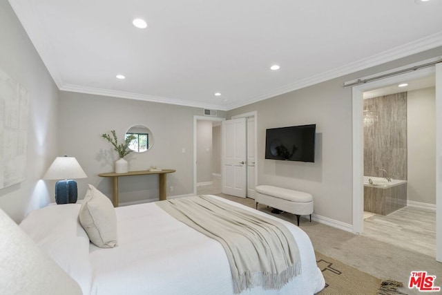 bedroom featuring crown molding, connected bathroom, and light carpet