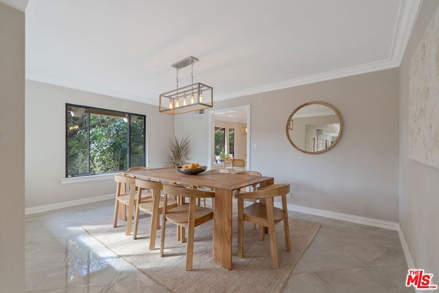 dining area featuring crown molding and a notable chandelier