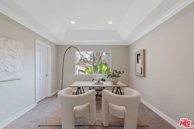 carpeted dining area with a tray ceiling