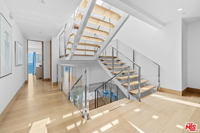 stairway featuring wood-type flooring