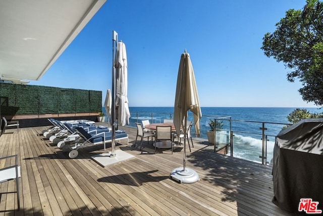 wooden deck with a grill and a water view