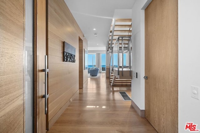 corridor with wood-type flooring