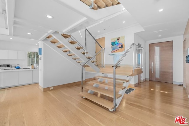 stairway with hardwood / wood-style floors