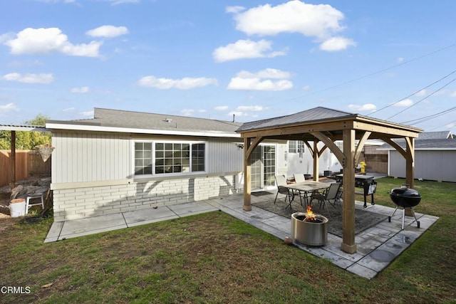 back of house with a gazebo, a patio area, and a lawn