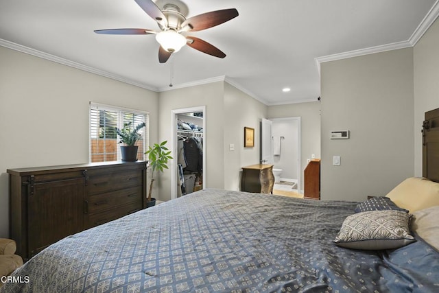 bedroom featuring ensuite bathroom, a walk in closet, ornamental molding, a closet, and ceiling fan