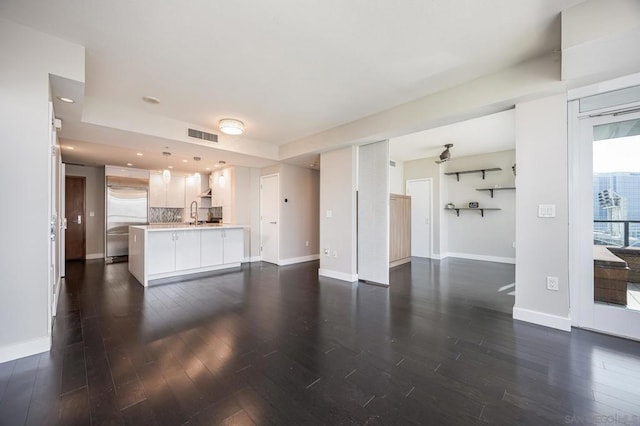 living room with dark hardwood / wood-style floors and sink