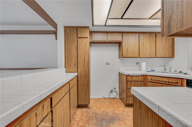 kitchen featuring sink and tile countertops