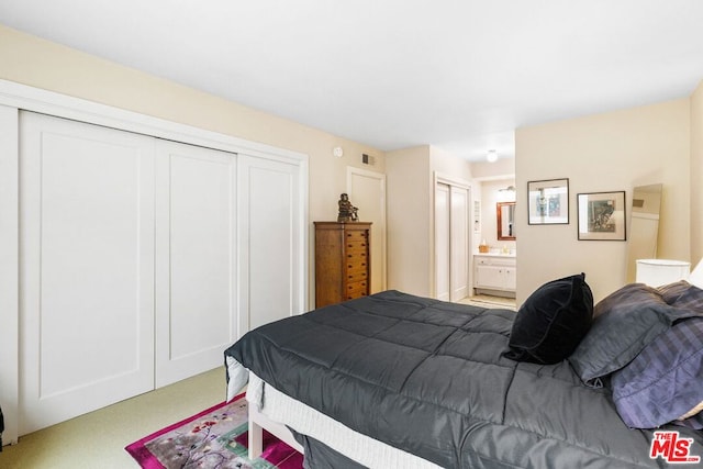 carpeted bedroom featuring ensuite bathroom