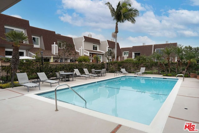 view of swimming pool with a patio area