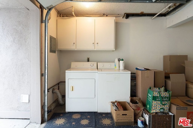 laundry area featuring cabinets and washer and clothes dryer