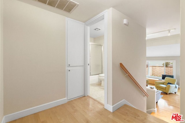 stairs with hardwood / wood-style floors