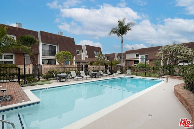 view of swimming pool with a patio area