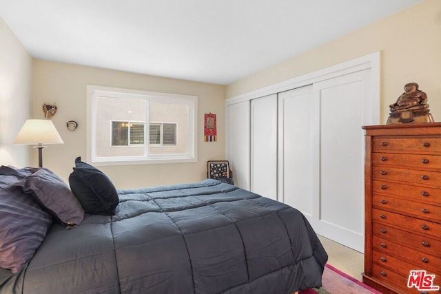 carpeted bedroom featuring a closet