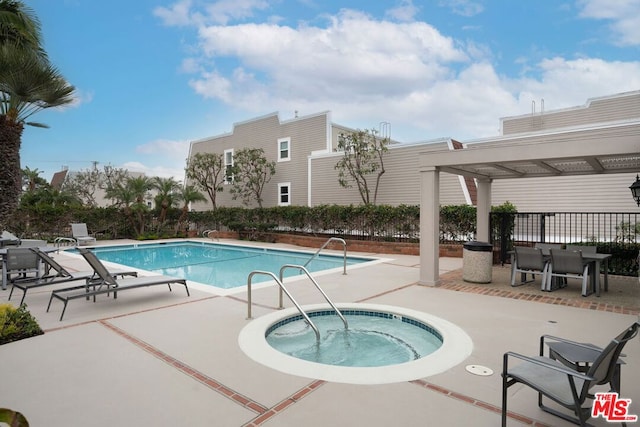 view of swimming pool with a community hot tub and a patio area