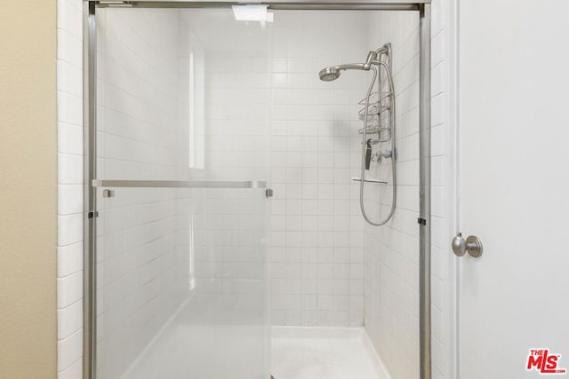 bathroom with a shower with shower door