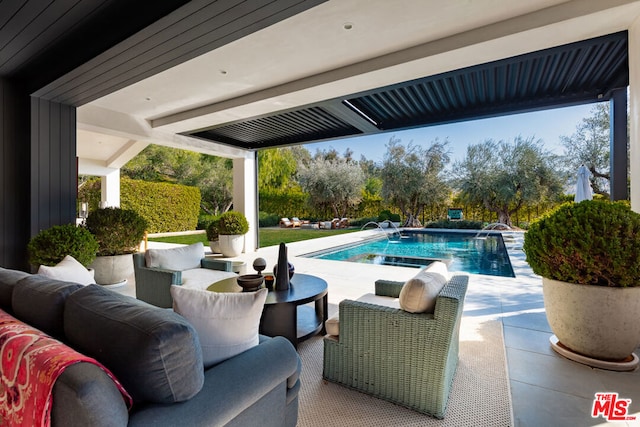 view of pool with outdoor lounge area and a patio