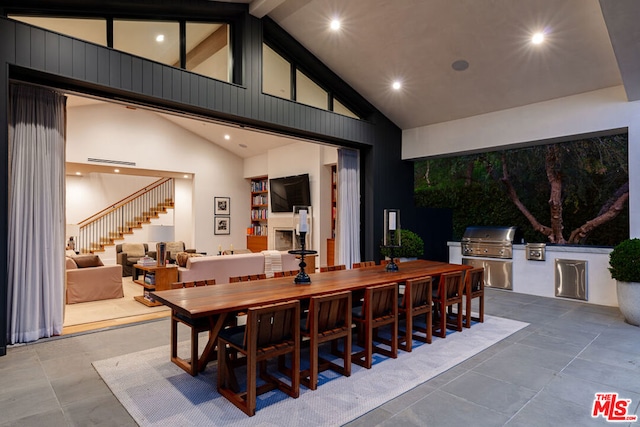 dining area featuring high vaulted ceiling