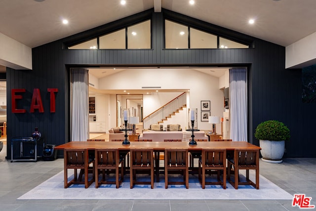 interior space featuring tile patterned flooring and high vaulted ceiling