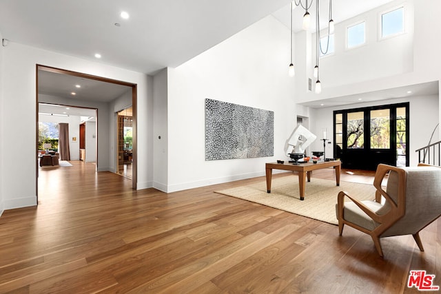 interior space featuring hardwood / wood-style flooring and a towering ceiling