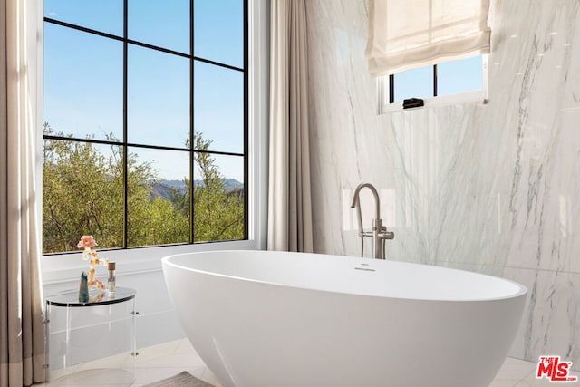 bathroom with a tub to relax in