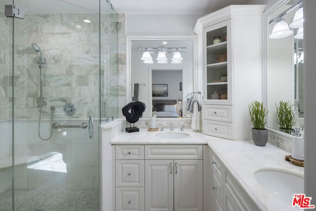 bathroom featuring walk in shower and vanity