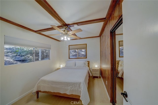 bedroom featuring crown molding, ceiling fan, and light hardwood / wood-style floors