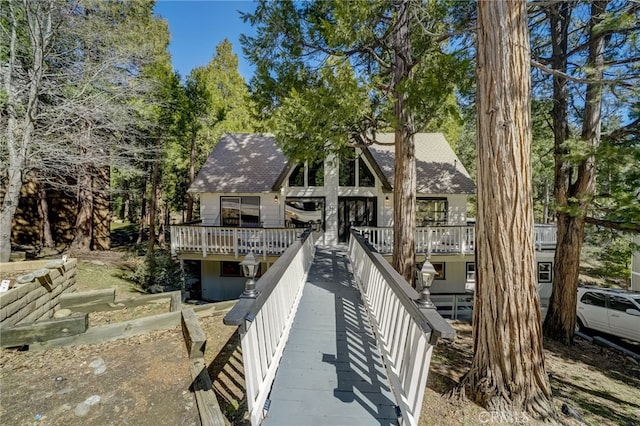 rear view of property with a wooden deck