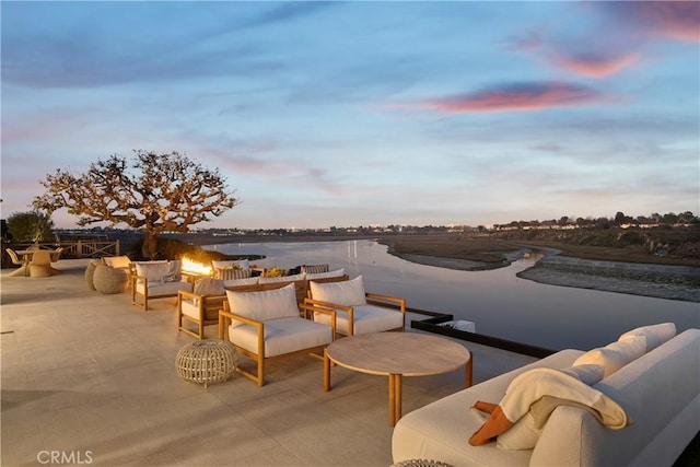 patio terrace at dusk with a water view