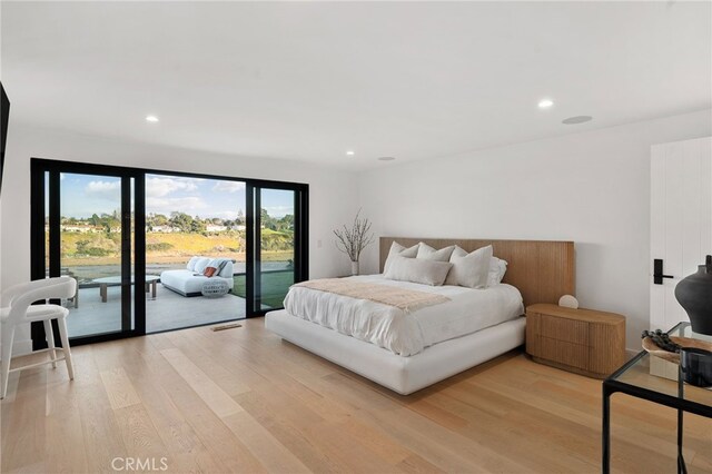 bedroom with access to outside and light wood-type flooring