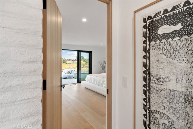 bedroom with access to outside and light wood-type flooring