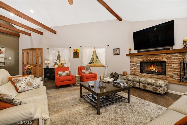 living room with lofted ceiling with beams, wood-type flooring, and a fireplace