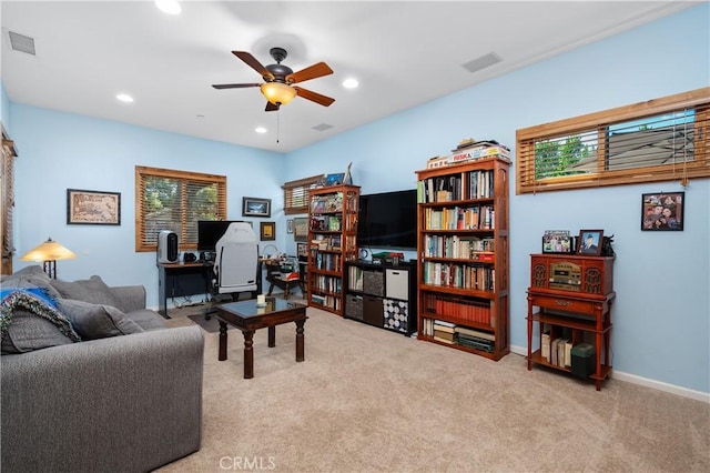 carpeted living room with ceiling fan