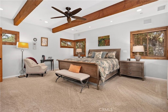 bedroom featuring ceiling fan, light carpet, and beam ceiling