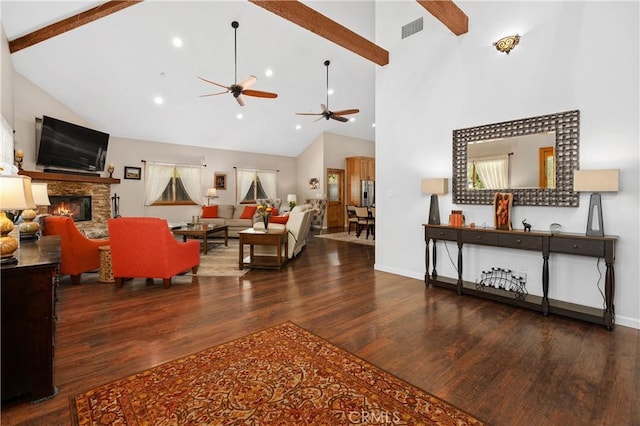 living room featuring dark wood-type flooring, a stone fireplace, high vaulted ceiling, and beam ceiling