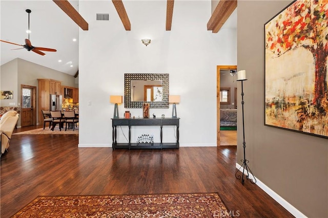 interior space featuring dark hardwood / wood-style flooring, high vaulted ceiling, and beam ceiling