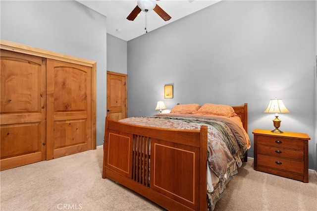 carpeted bedroom with a towering ceiling and ceiling fan