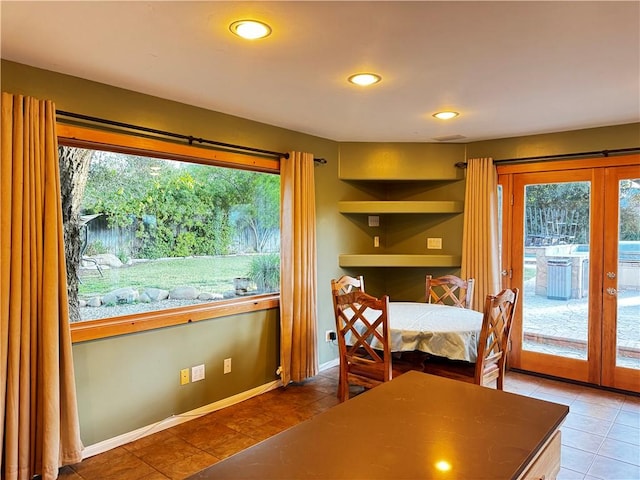 dining area featuring tile patterned flooring and french doors