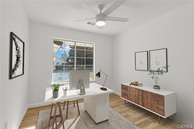 office with ceiling fan and light hardwood / wood-style flooring