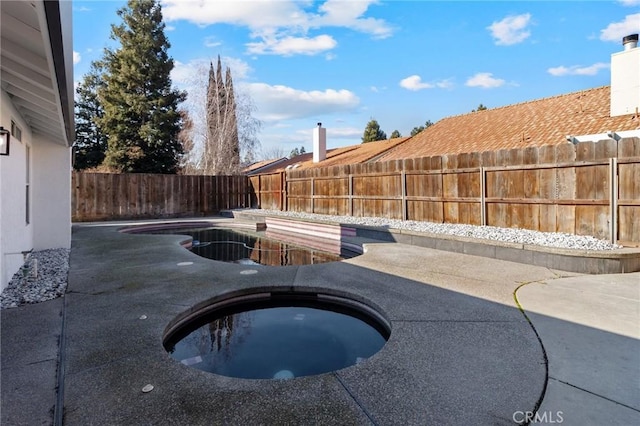 view of pool featuring an outdoor hot tub and a patio area