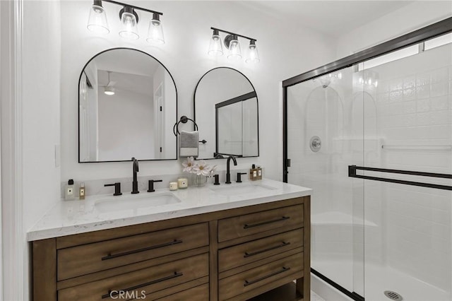 bathroom with vanity and a shower with door