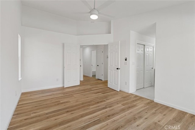 spare room featuring ceiling fan, vaulted ceiling, and light hardwood / wood-style floors