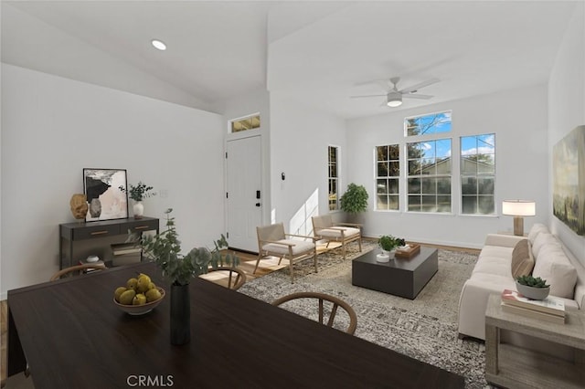 living room with ceiling fan, vaulted ceiling, and hardwood / wood-style floors