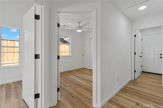 corridor with light hardwood / wood-style floors