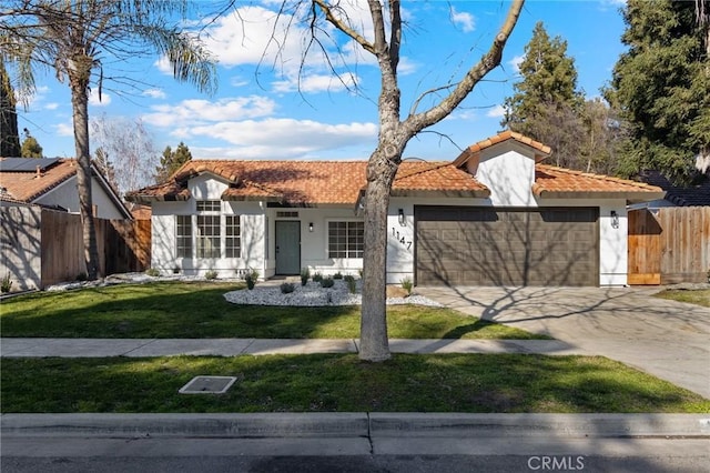 mediterranean / spanish home with a garage and a front yard