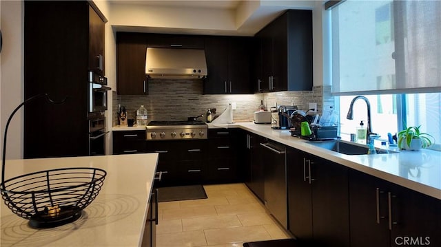 kitchen with extractor fan, sink, backsplash, oven, and stainless steel gas cooktop