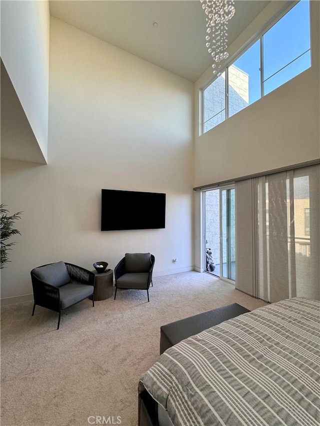 carpeted bedroom with a high ceiling