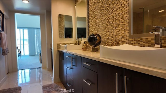 bathroom featuring vanity, backsplash, and tile patterned floors