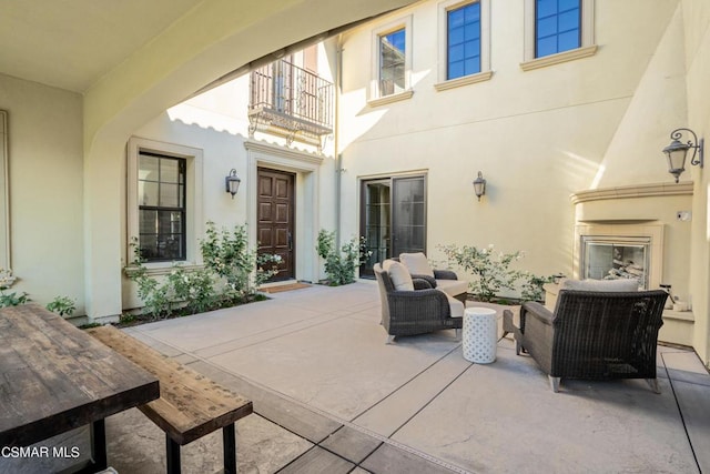 view of patio featuring an outdoor living space with a fireplace