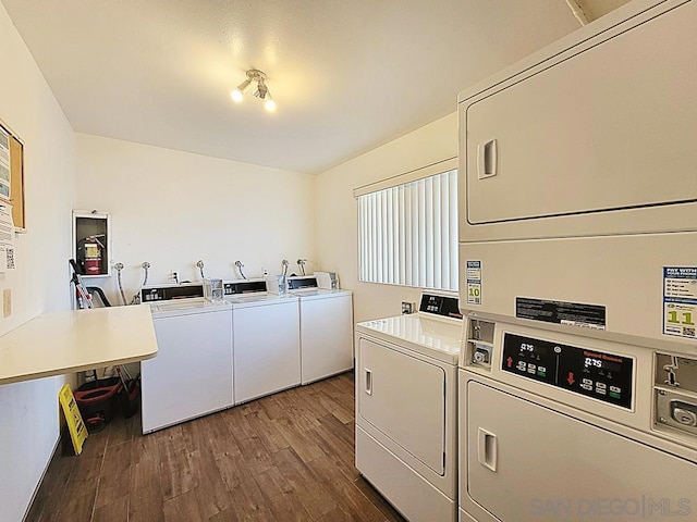 washroom featuring dark wood-type flooring, stacked washer and clothes dryer, and washer and dryer