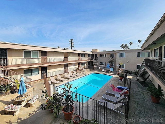 view of swimming pool featuring a patio area